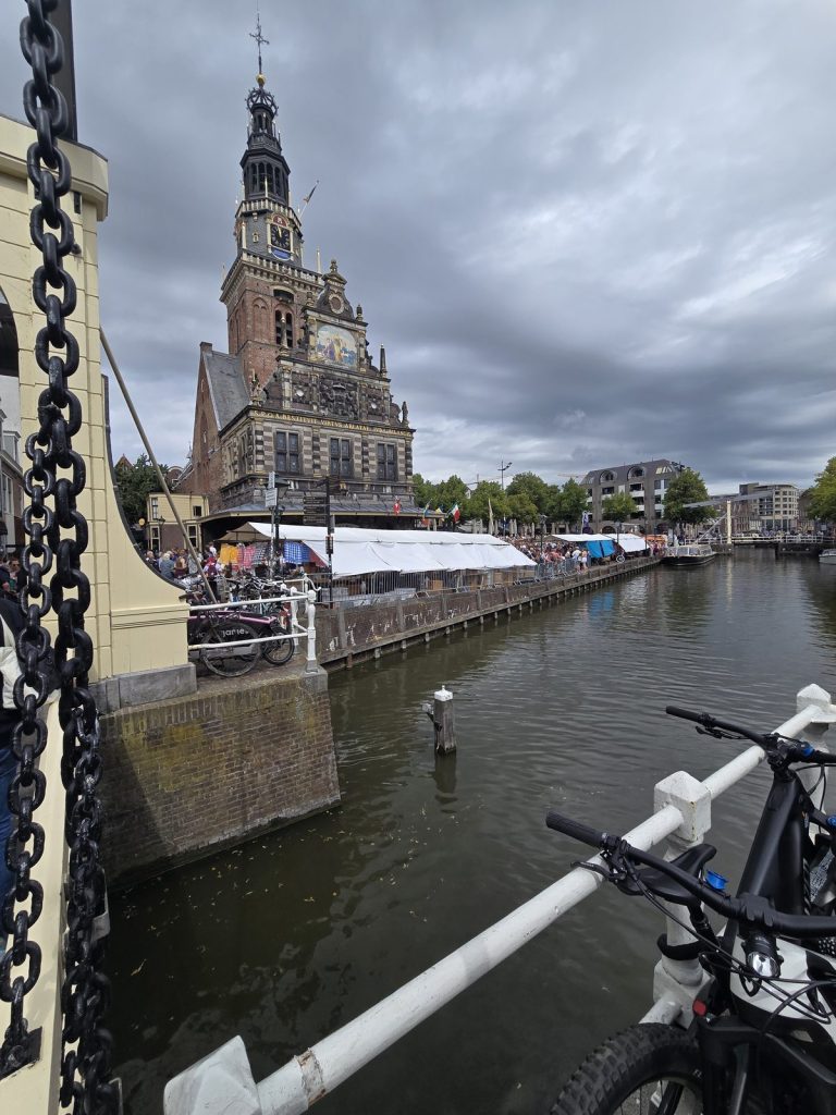 The Waag tower of Alkmaar seen from the canal under a moody Dutch sky